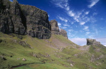 Quiraing Escarpment Mountains with walker on lower slopes.scree slopes