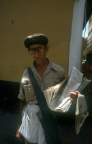 Newspaper vendor standing in the street