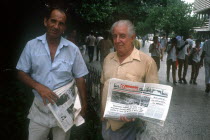 Newspaper vendors standing in the street