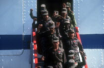 Waving soldiers returning from Angola walking down the gangway from a ship