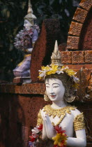 Wat Bupparam Temple on Tha Phae Road. Detail of brightly coloured Buddha statues decorated with floral garlands.bupharam Asian Colored Prathet Thai Raja Anachakra Thai Religion Siam Southeast Asia Re...