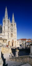 Cathedral.  View from flight of stone steps in the foreground towards gothic facade and twin spires.