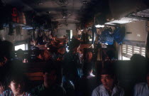 The crowded interior of a third class train compartment travelling from Nhetang to Ho Chi Minh City.