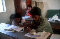 Students reading at their desk during literacy classes in Cambodia.