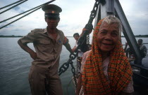 Passengers on the Mekong ferry  old woman and soldier.