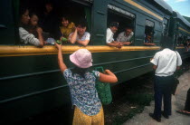 Selling fruit to train passengers.