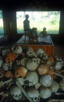 Children behind a pile of bones of Killing Field victims