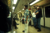 Passengers standing in MRT Mass Rapid Transport train carriage