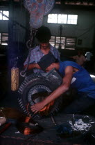 Light industry  man in workshop fitting copper wire on to reel