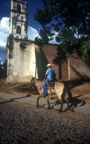 Horseman on cobbled street