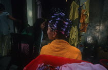 Vietnam, Hanoi, Woman with curlers in her hair.