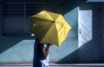 Woman with yellow umbrella in the street