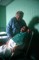 Pregnant woman in labour being attended by hospital nurse