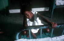 Pregnant woman eduring labour pains in hospital ward