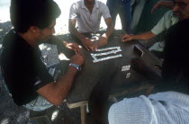 Domino players sitting around the table