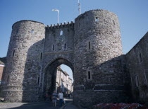 Stone gatehouse with people walking through.European Great Britain Northern Europe UK United Kingdom Blue British Isles Destination Destinations Gray Holidaymakers Tourism Tourist European Great Bri...