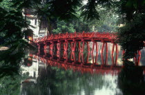 Le Petit Lac at Hoan Kiem Lake.  The red painted Huc bridge  reflected in the lake  leading to Ngoc Son Temple