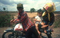 National Route 6.  Motorbike rider with woman and baby on pillion.