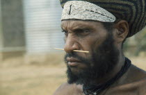 Portrait of a Melpa warrior with nasal piercing and beaded headband