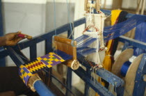 Weaving contemporary kente cloth designs.