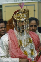 Portrait of  Sikh Bridegroom with gold and silver veil over his face.