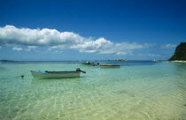 Fishing boats moored in clear  shallow water near beach. Indian Ocean