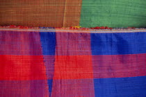 Detail of coloured woven textile for sale in the souq.