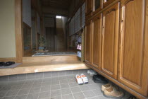 Entrance to modern family home with removed shoes left by step.