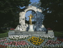 City Park. Johan Strauss statue with flower beds in the foregroundStadtpark