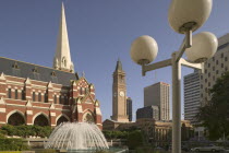 View of Brisbane City Hall in King George Square with the Albert Street Unit Church in the foreground.