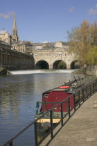 View of Pulteney Bridge with canal boat in foreground on the River Avon.