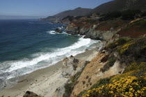 Pacific Coast Highway. View over sandy bay and rocky coastline