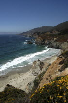 Pacific Coast Highway. View over sandy bay and rocky coastline