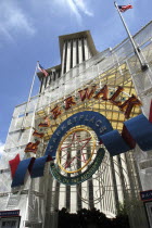 Angled view looking up athe Riverwalk Marketplace entrance sign with highrise buildings behind