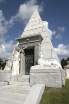 Graveyard pyramid shaped vault with statue of sphinx and man outside