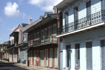 French Quarter. View along row of pastel coloured buildings with ironwork balconies