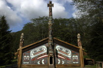 Wooden hut with carved wooden Totem pole entrance in the Totem Park