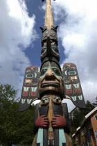 Angled view of carved wooden Totem pole in the Totem Park