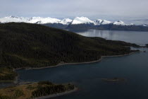 View along coastline toward snow capped mountain peaks