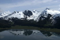 View over waters toward snow capped mountain peaks