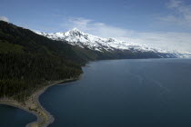 View along the coast toward snow capped mountain peaks