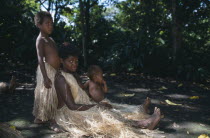 Tanna.  Kastom traditional village tribeswoman and children.