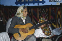 Hutsul woman playing a guitar.