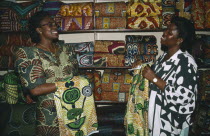 Female cloth vendors selling traditional cloth at market.