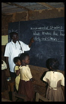 Teacher and children in primary school studying environmental issues.