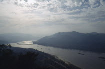 Bend in river and surrounding landscape in low light.