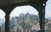 Sighisoara.  View of town rooftops framed by archway.  Famous as being the birthplace of Vlad Tepes or Dracula.