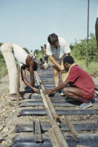 Construction workers under supervision on Canadian run railway.