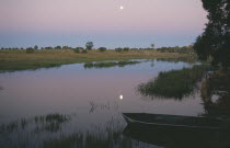 Full moon reflected in the river at dusk.