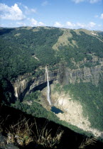 Waterfall cascading from plateau into plunge pool below Cherrapunjee